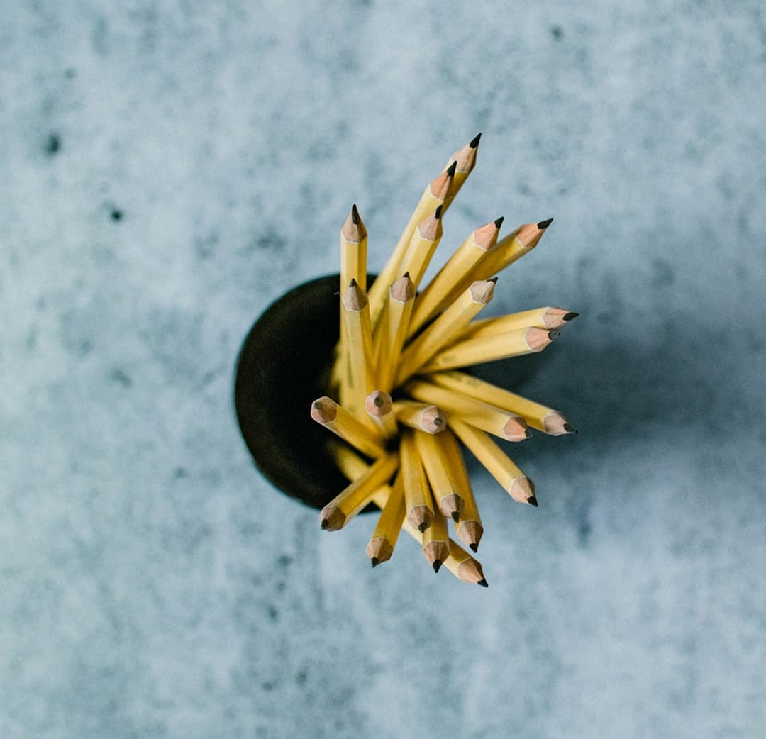 Pencils in a cup from above, symbolizing assessment and learning.