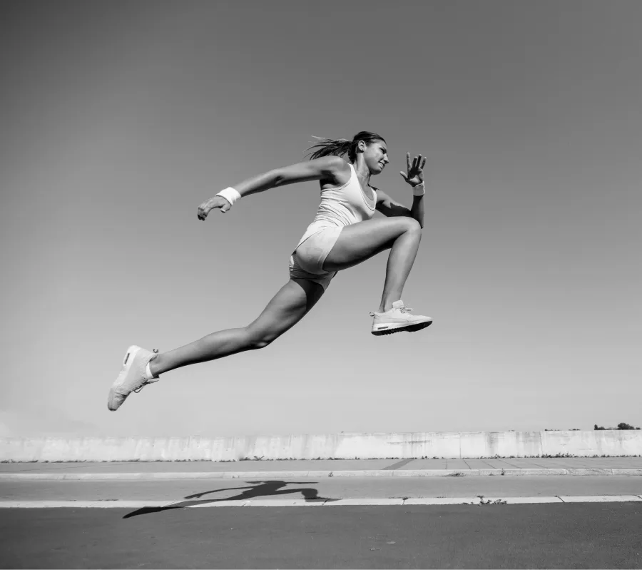 Track and field athlete in the triple jump, representing sport psychology and performance.